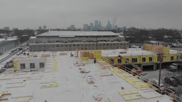 building in construction with downtown Minneapolis at the background