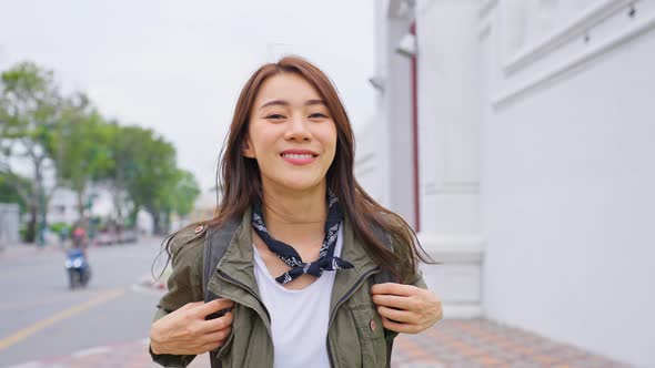 Portrait of Asian attractive woman backpacker travel in beautiful city.