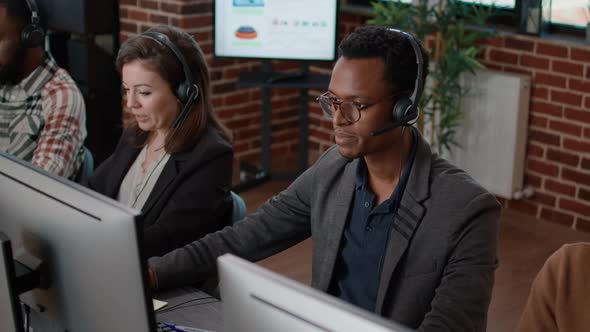 African American Man and Caucasian Woman Working at Call Center