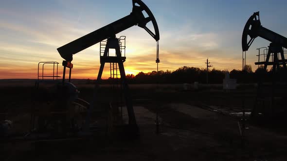Flying Around Working Oil Pumps at Sunset