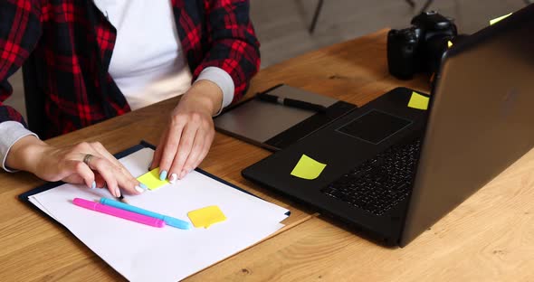 Photographer Female Working in a Creative Office Make Notes and Retouch Photo on Laptop