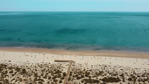 Beautiful Altura beach in Portugal on a hot summer day -Aerial