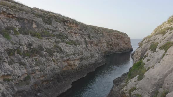 Stone walls of the Wied il-Għasri sea canyon valley,Malta,aerial shot.