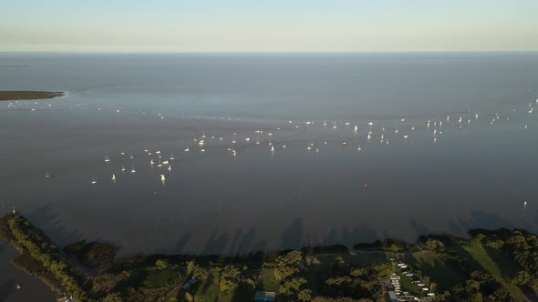 Aerial view of La Plata river with some boats sailing near shore at Buenos Aires