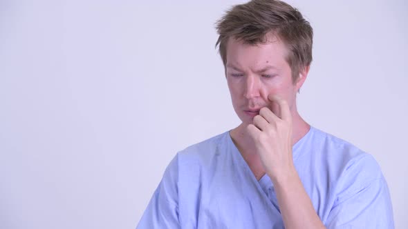 Portrait of Stressed Young Man Patient Thinking and Looking Down