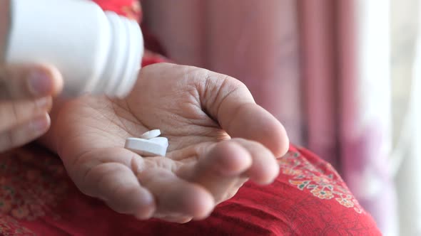 Close Up of Women Hand Taking Pills 