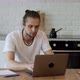 A Freelancer Works at a Laptop At Home, Sits at A Table in A Bright Room, Creates A New Project - VideoHive Item for Sale