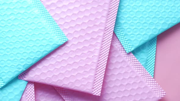 Pink and v Blue Paper Bubble Envelope on Table