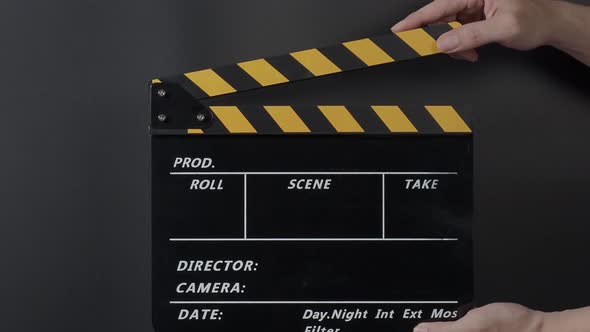 Movie clapperboard footage. Man hand holding film slate and clapping it in studio before shooting