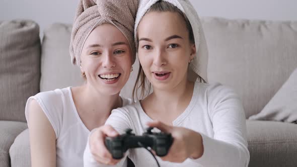 Smiling Women Friends Playing Video Games at Home