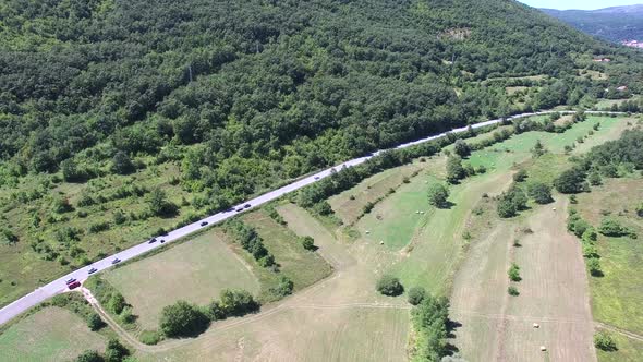 Aerial view of highway through green forested hills, Croatia