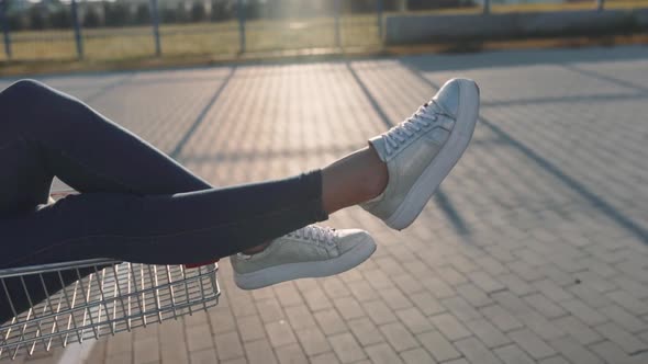 Couple in Love in a Supermarket Parking Lot with a Trolley From the Store at Sunset