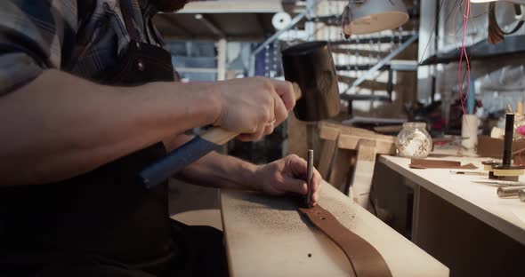 Craftsman Punching Holes on Belt