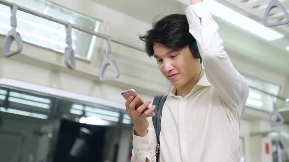 Businessman Using Mobile Phone on Public Train