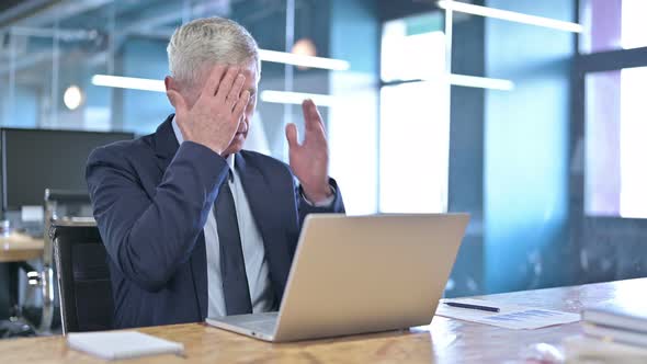 Tired Middle Aged Businessman Having Headache in Office