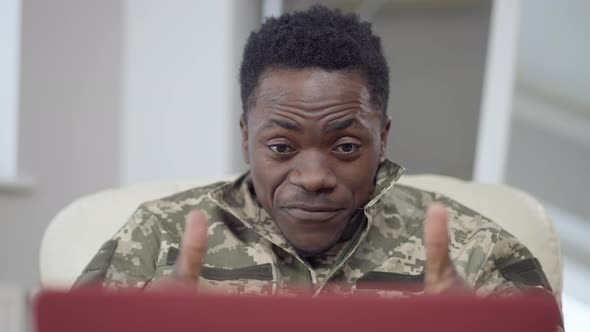 Closeup Portrait of Cheerful Handsome African American Soldier Talking in Video Chat Gesturing and