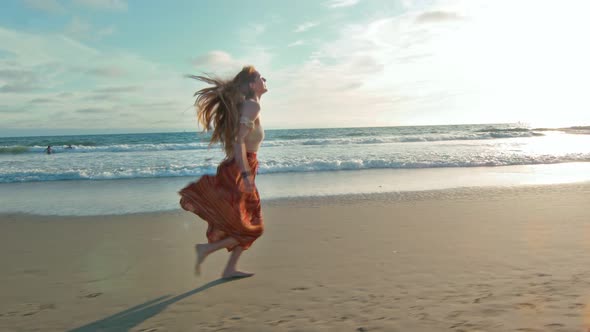 Slow Motion of Young Woman Running at the Beach