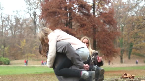 Father putting daughter on tree stump