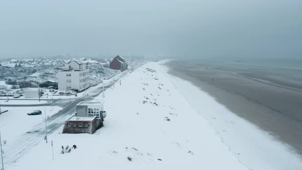 Seawall of Dunkirk in snow with some people, Dunkerque, France