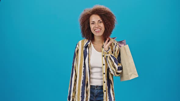 African American Woman Holds Paper Bags After Shopping