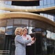 Smiling Businesswomen Having Discussion Standing in Front of Building - VideoHive Item for Sale