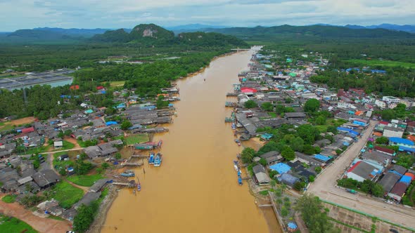 Aerial shot of river and local fisherman village beside the sea