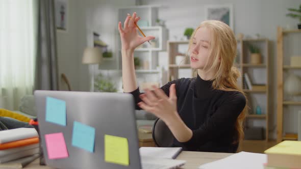 Young Woman Discussing Video Call at Home in Living Room at the Desk