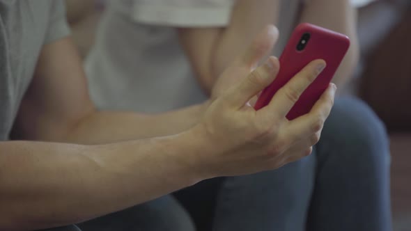 Unrecognized Angry Man Shouting at His Girlfriend Showing Her Cellphone with Messages From Her Lover