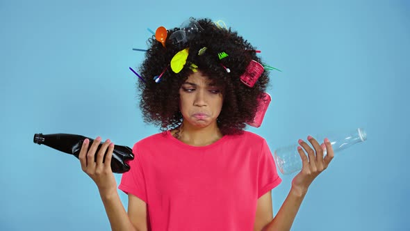 Unhappy woman holding two plastic bottles.