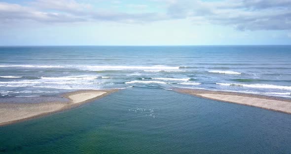 Stunning aerial where the Mokihinui River Mouth meets the Tasman Sea in New Zealand - Aerial Dolly-i
