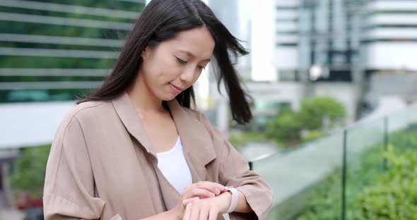 Business woman use of smart watch at outdoor