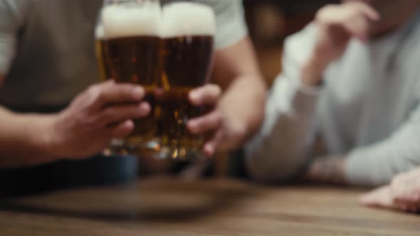 Close up of unrecognizable man bringing beer glasses for friends. Shot with RED helium camera in 8K.