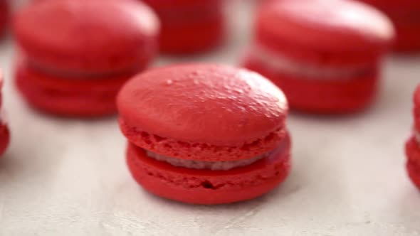 Closeup View of Many Rows of Red Macarons Macaroon on White Background