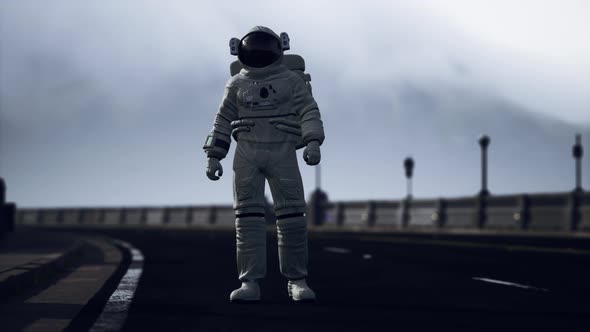 Astronaut Walks in the Middle of a Road alt