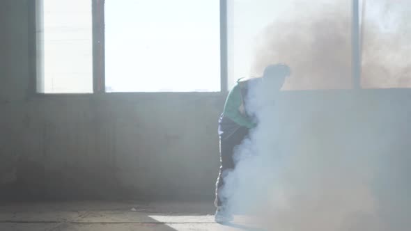 Skillful Young Rapper Dancing in an Abandoned Building in the Fog