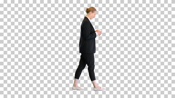 Beautiful young blond business woman walking, Alpha Channel