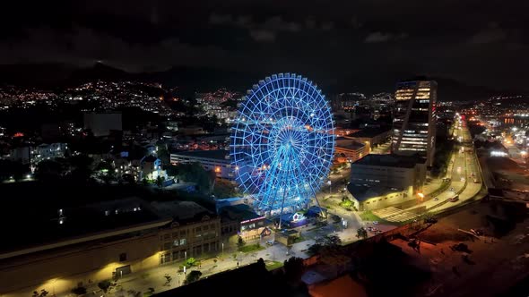 Night landscape of illuminated colorful ferris wheel at Rio de Janeiro Brazil