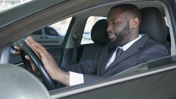 Businessman Sitting in Car and Drumming Fingers Against Steering Wheel, Anxiety