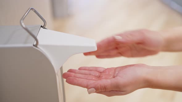 Closeup Female Hands Press the Diffuser of Liquid Alcohol Hand Sanitizer