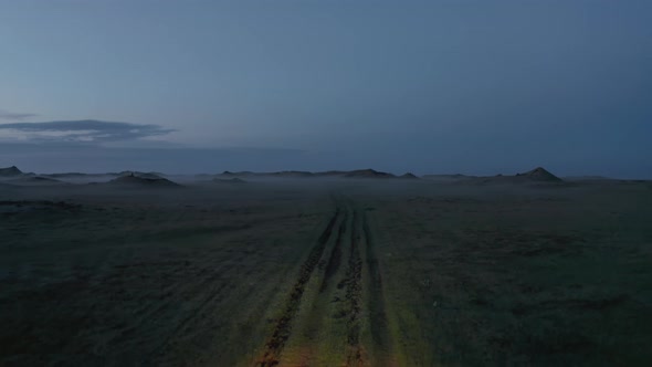 Aerial View Flying Towards Adventurous Car Driving on Wild Trail in Iceland Countryside