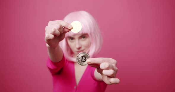 Beautiful Woman Holds a Bitcoin in Her Hand She Shows It Close Up