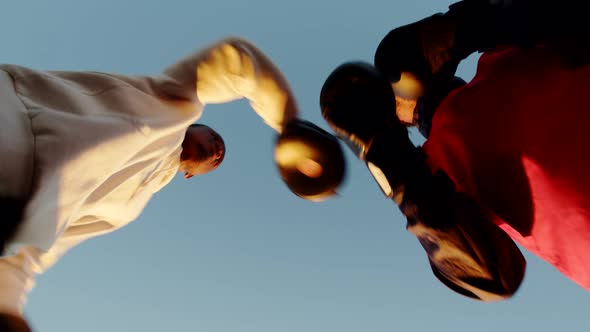 Two Black Men Training Boxing Against Background Sunset Outdoors Bottom View