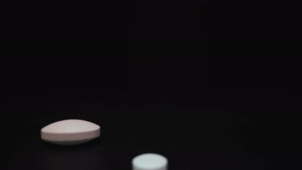 Different Pills and Capsules for Virus on Black Background