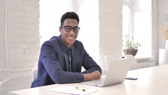 Smiling Businessman at Work Looking at Camera