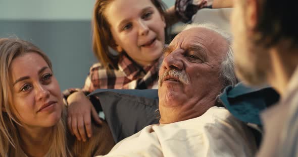 Elderly Patient and Visitors Speaking with Doctor