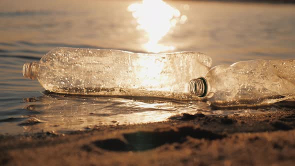 Plastic Debris on the Beach Swaying on the Waves