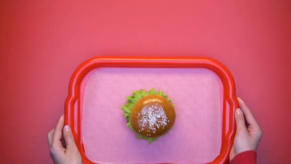 Hands Putting Tray With Tasty Burger Salad on Bright Background, Take Away