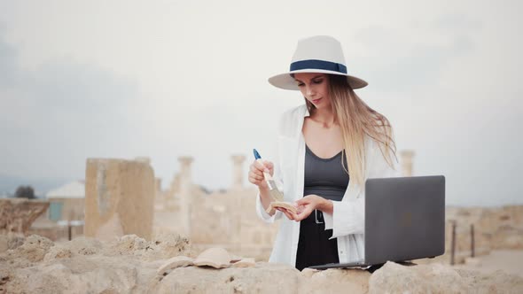 Archeologist Using Laptop While Digging Ancient Temple