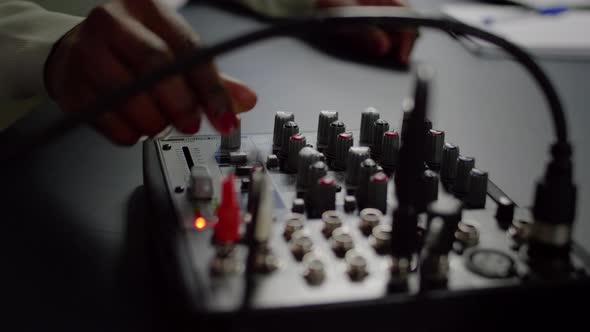 Close Up of Afro Vlogger Making Sound Adjustments