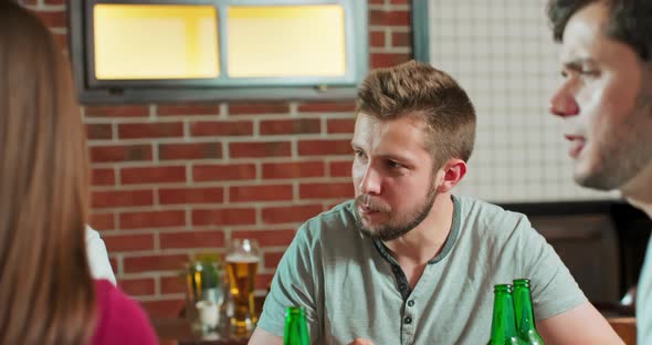 In the Bar Restaurant Group of Diverse Young Man Talking with Friends Eat Chiken They